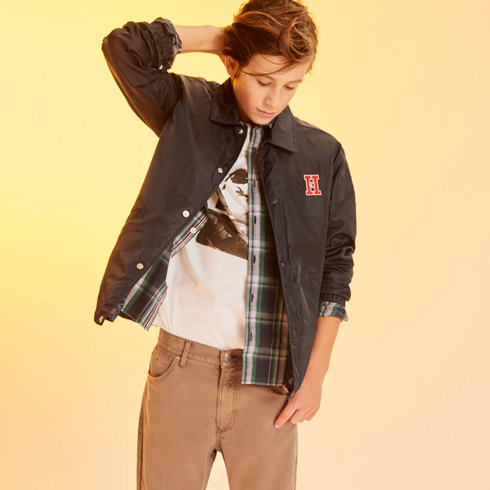 Shop for him, shop for her THE HIT LIST. New arrivals destined for heavy wardrobe rotation. Boy model wearing a jacket, flannel shirt and graphic tee with pants.
