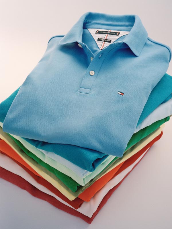 A stack of Tommy Hilfiger polo shirts in bright spring colors.