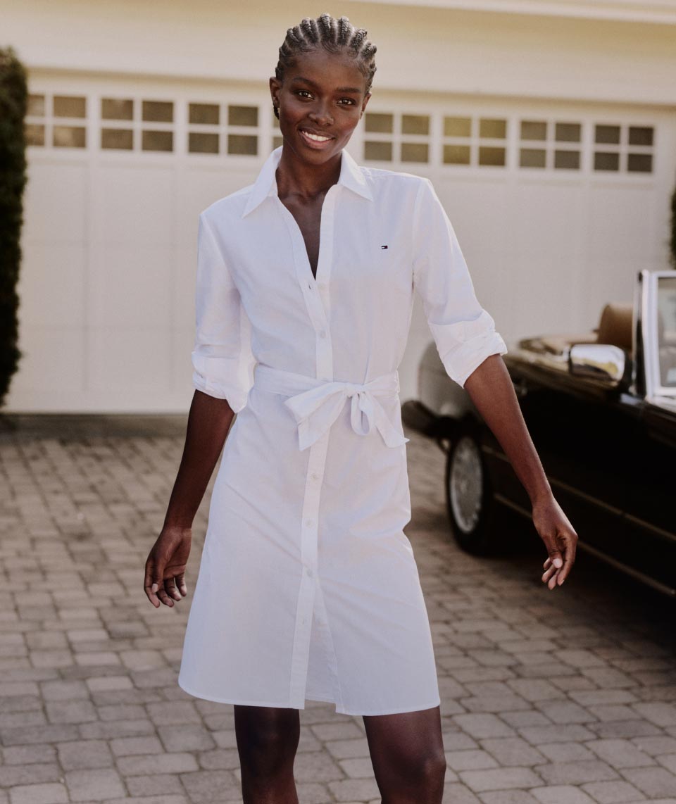 A female model wears a Tommy Hilfiger white shirtdress.