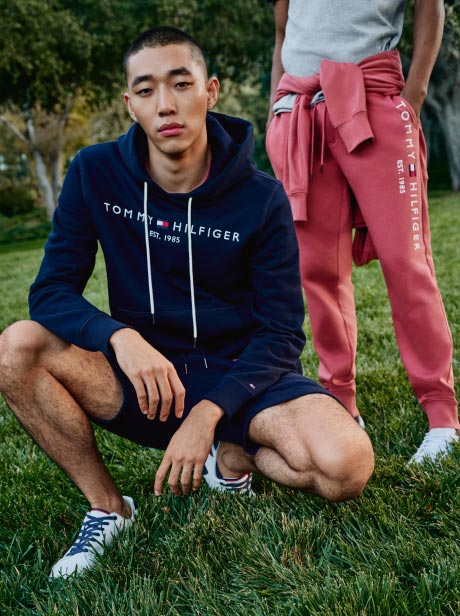 Two male models wear new season T-shirts, hoodies and shorts from Tommy Hilfiger.