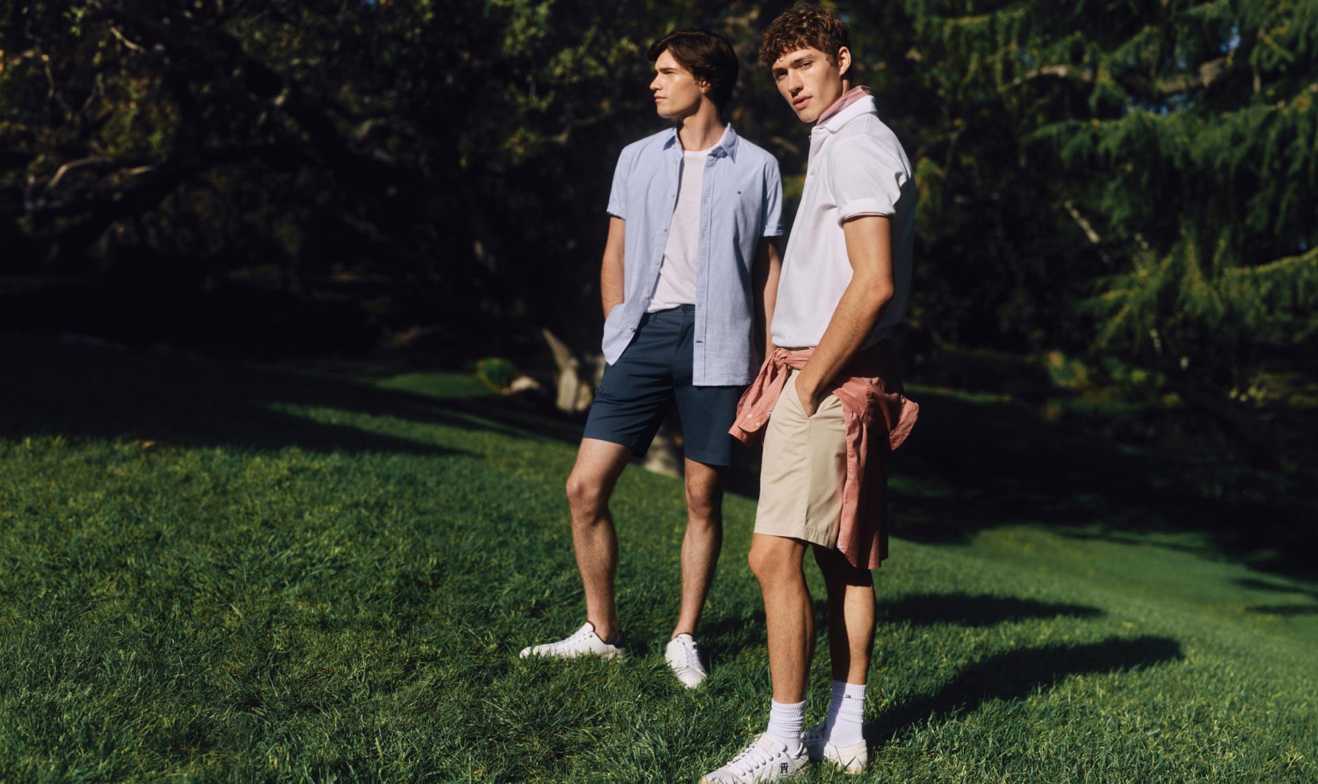 Two male models wear Tommy Hilfiger shorts.