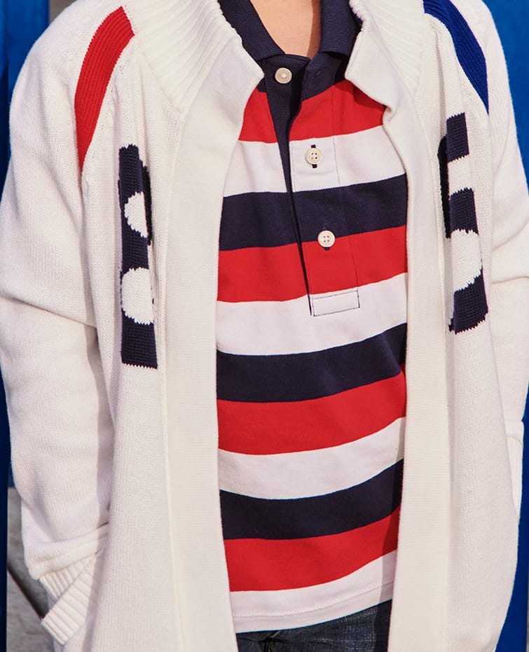 SUMMER SHOUT OUT Fun colors and graphics, new for kids from Tommy Adaptive. Boy model wearing striped polo, open-front sweater and jeans, all designed with hidden features that make dressing easier.