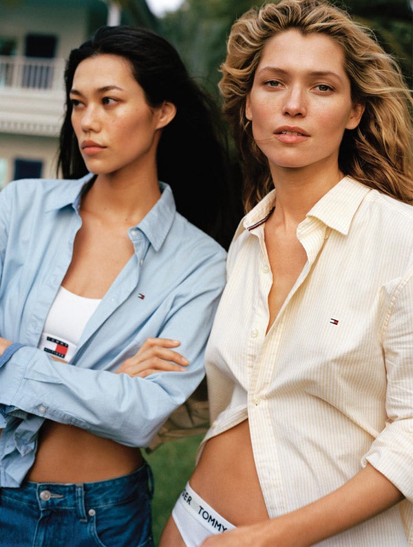 Two female models wear new season apparel for summer from Tommy Hilfiger.