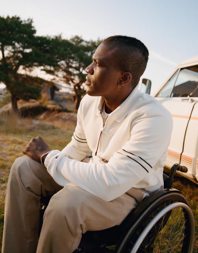 A male model wears new season apparel from Tommy Hilfiger Adaptive, featuring unique closures that help make dressing easier.