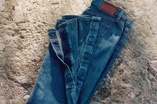 A pair of jeans from Tommy Hilfiger Adaptive featuring magnetic closures at the hem to accomodate leg braces, orthotics and casts.