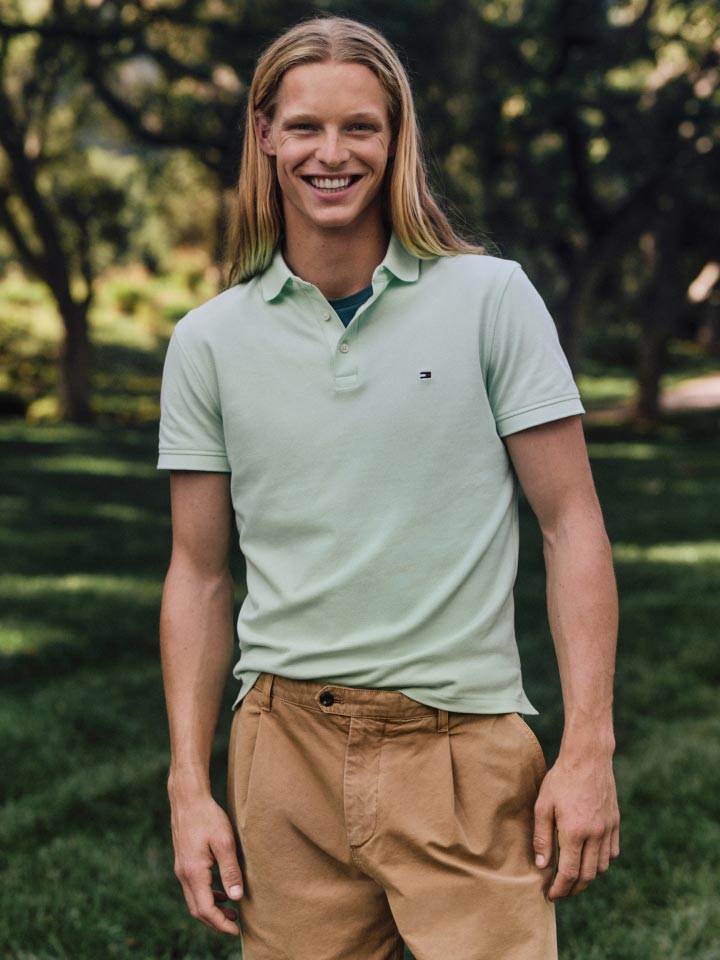 A male model wears a new season polo from Tommy Hilfiger.
