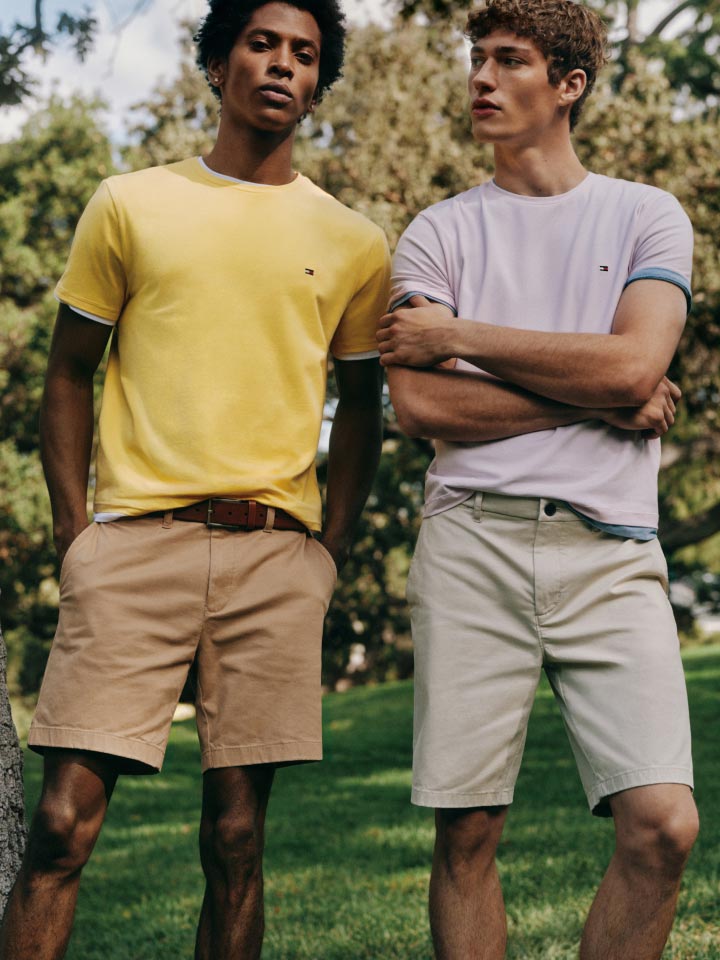 Two male models wear T-shirts and shorts, new from Tommy Hilfiger.