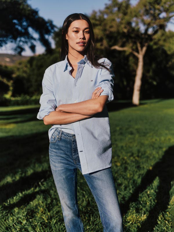 A female model wears an Oxford shirt, new from Tommy Hilfiger.