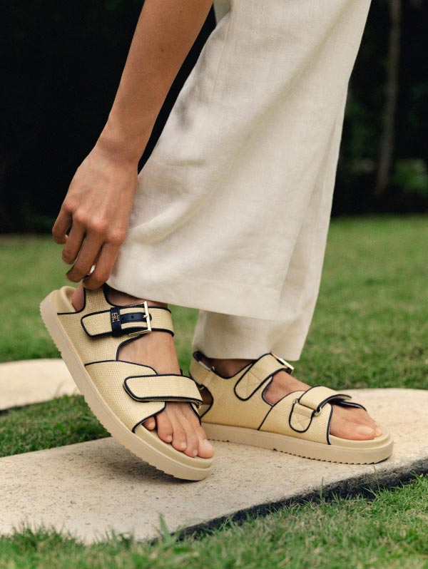 A female model wears new spring sandals from Tommy Hilfiger.