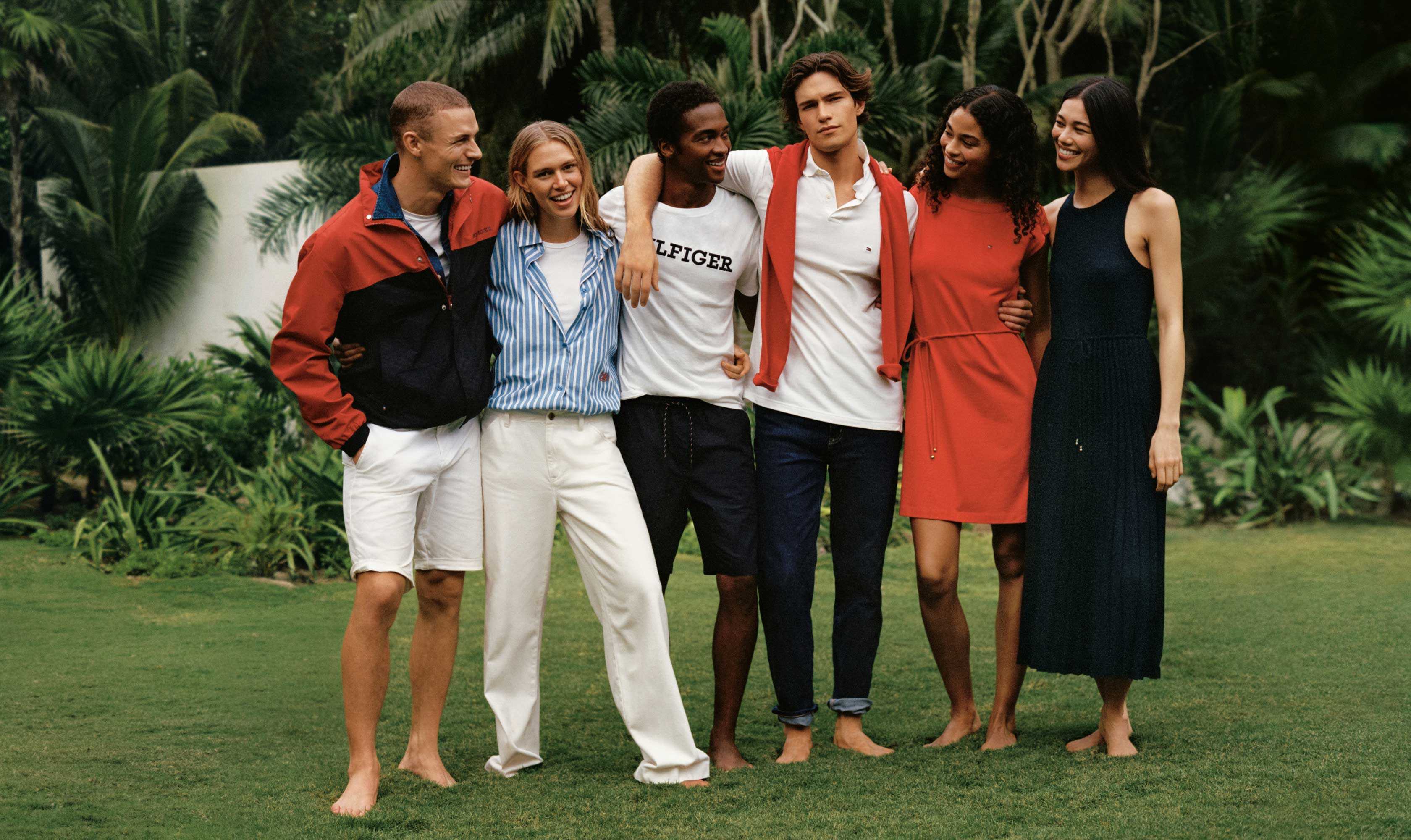 A group of male and female models wear Tommy Hilfiger styles in red, white and blue.