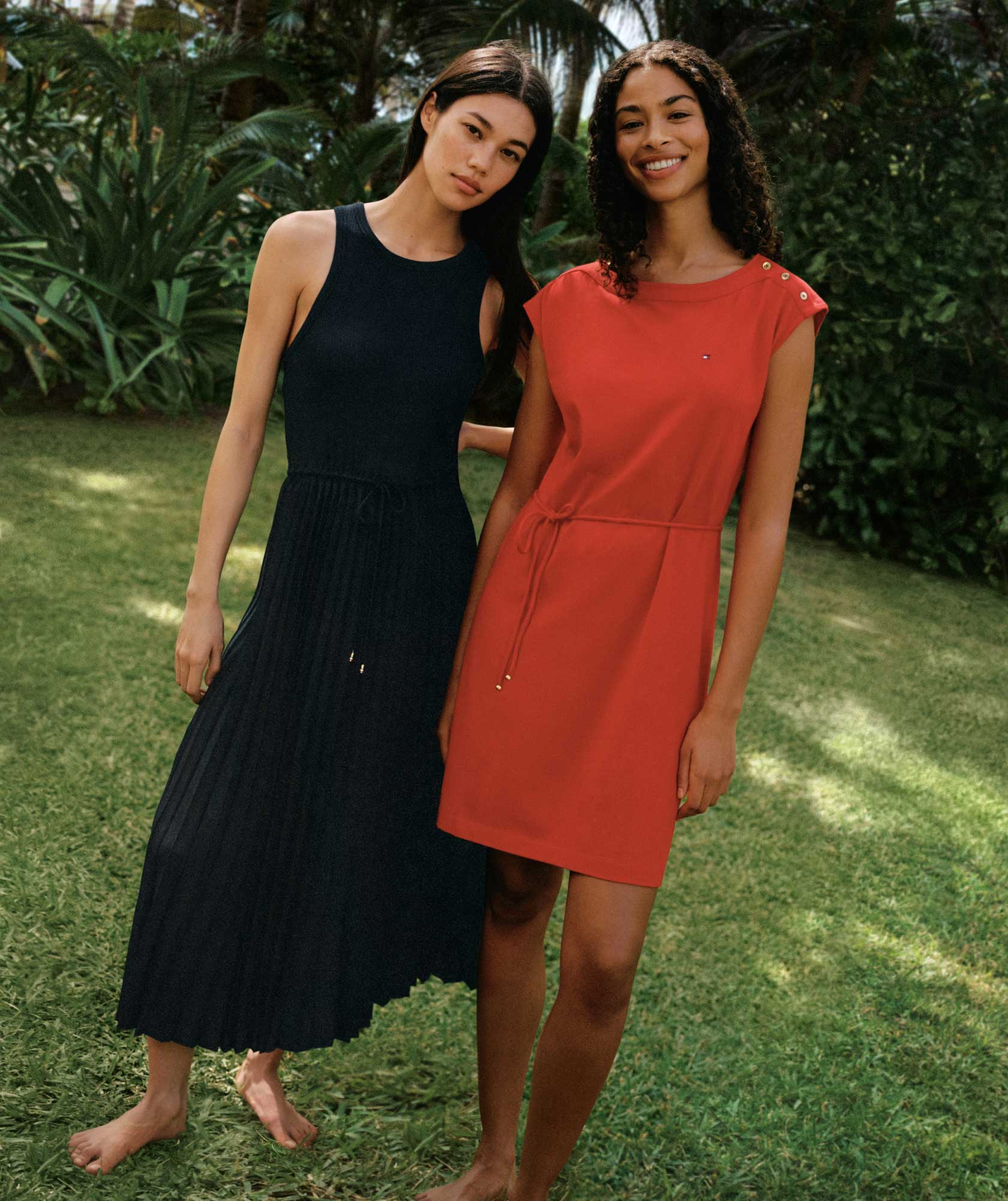 Two female models wear summer dresses from Tommy Hilfiger.