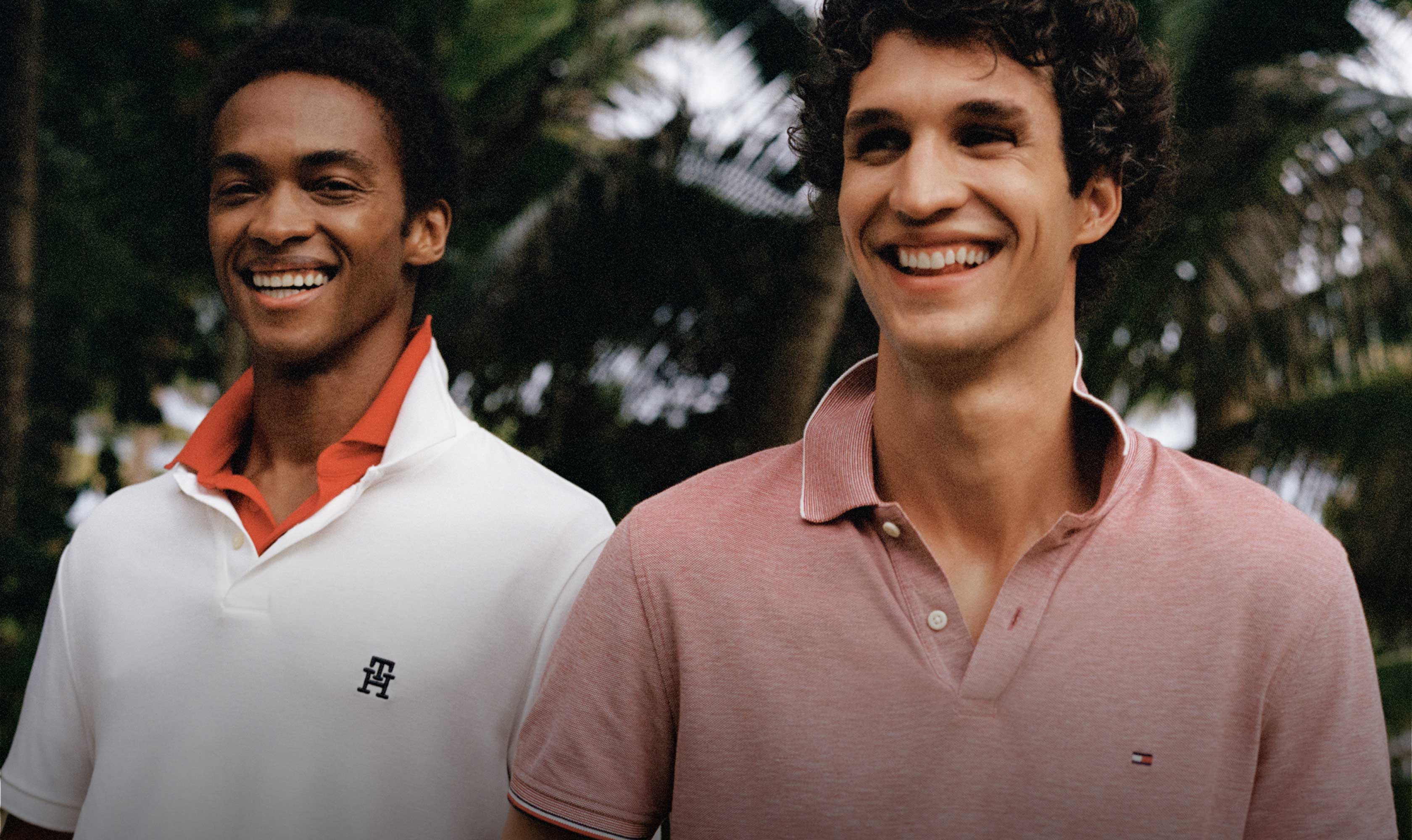 Three male models wear Tommy Hilfiger polos in red, white and blue.