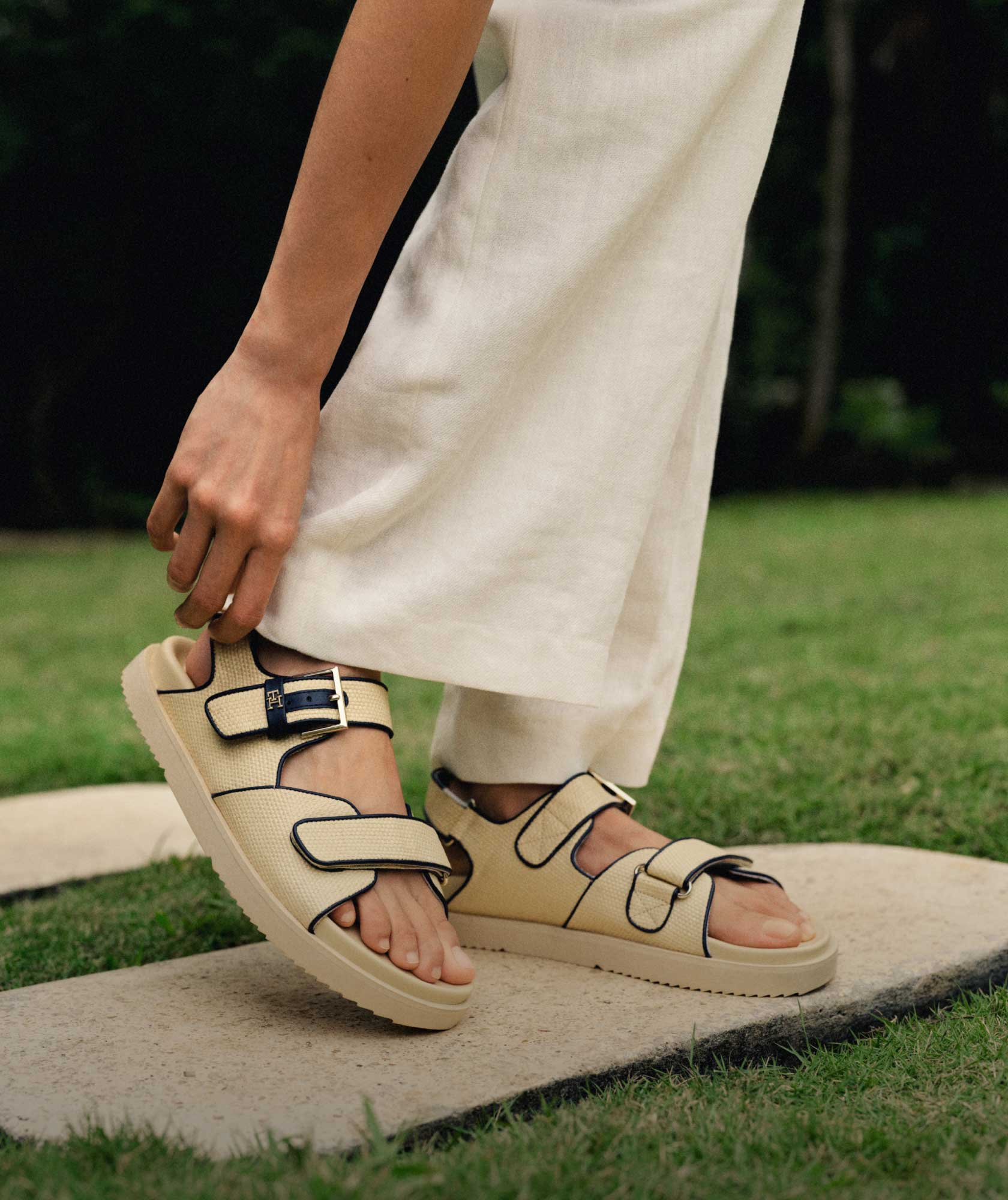A female model wears new summer sandals from Tommy Hilfiger.