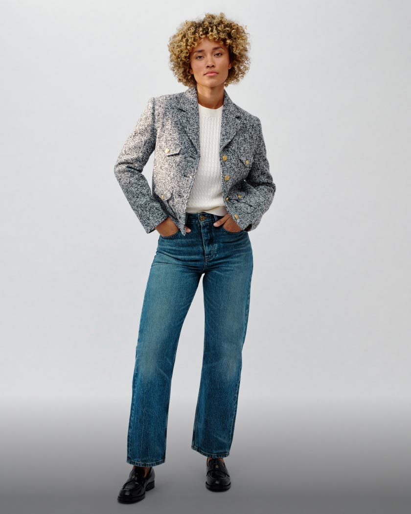 Elle Smith wears a cable knit sweater and mid rise jeans for the Tommy Hilfiger Fall Fashion Show.