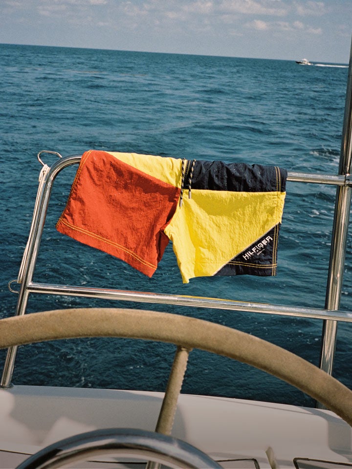 Tommy hilfiger swim trunks hanging on a boat