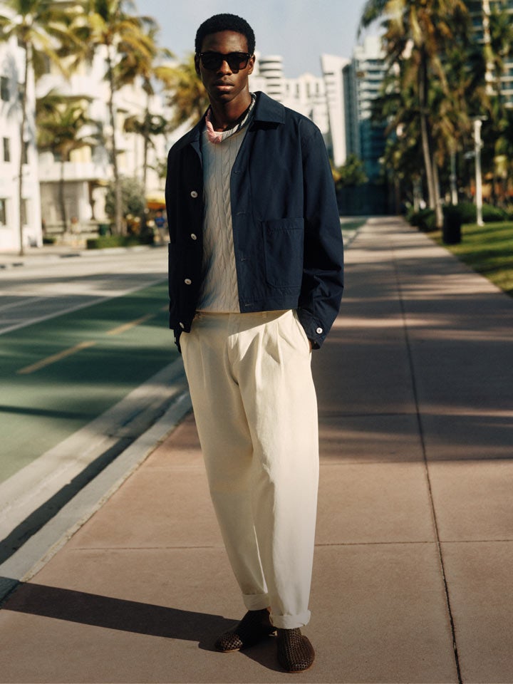 Man standing on the street wearing Tommy hilfiger jacket and linen pants