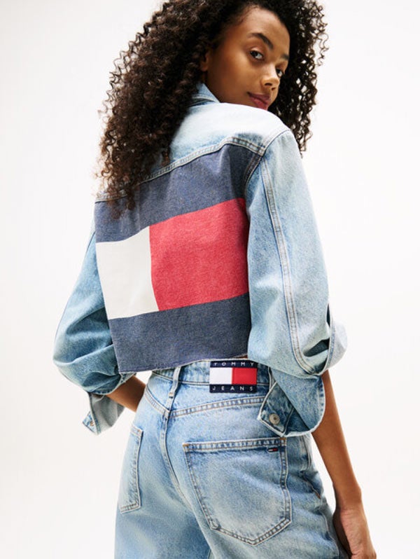 Woman looking over her shoulder wearing Tommy Hilfiger denim jacket and pants