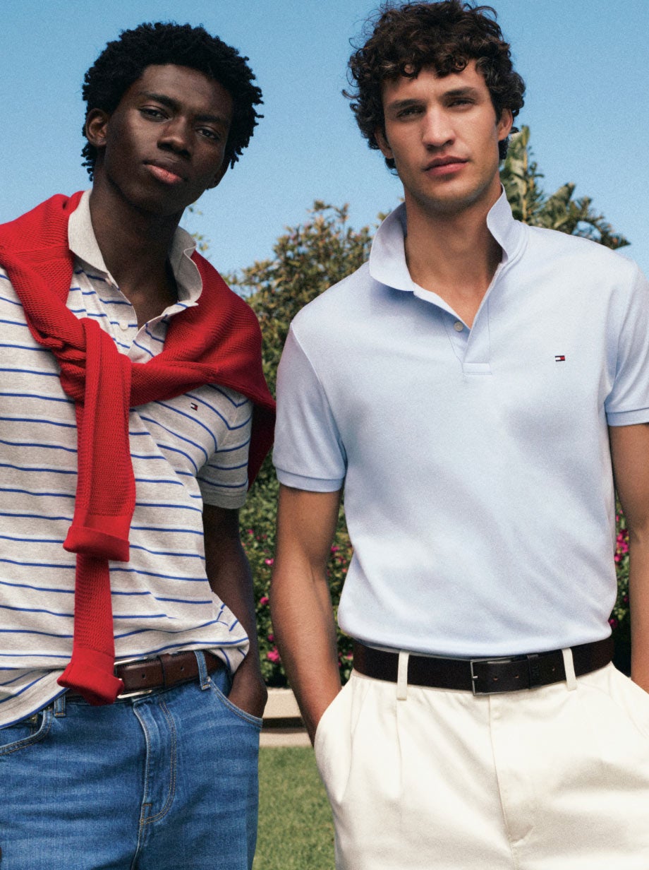 Two men wearing Tommy Hilfiger polos one with a sweater drapped over his shoulders