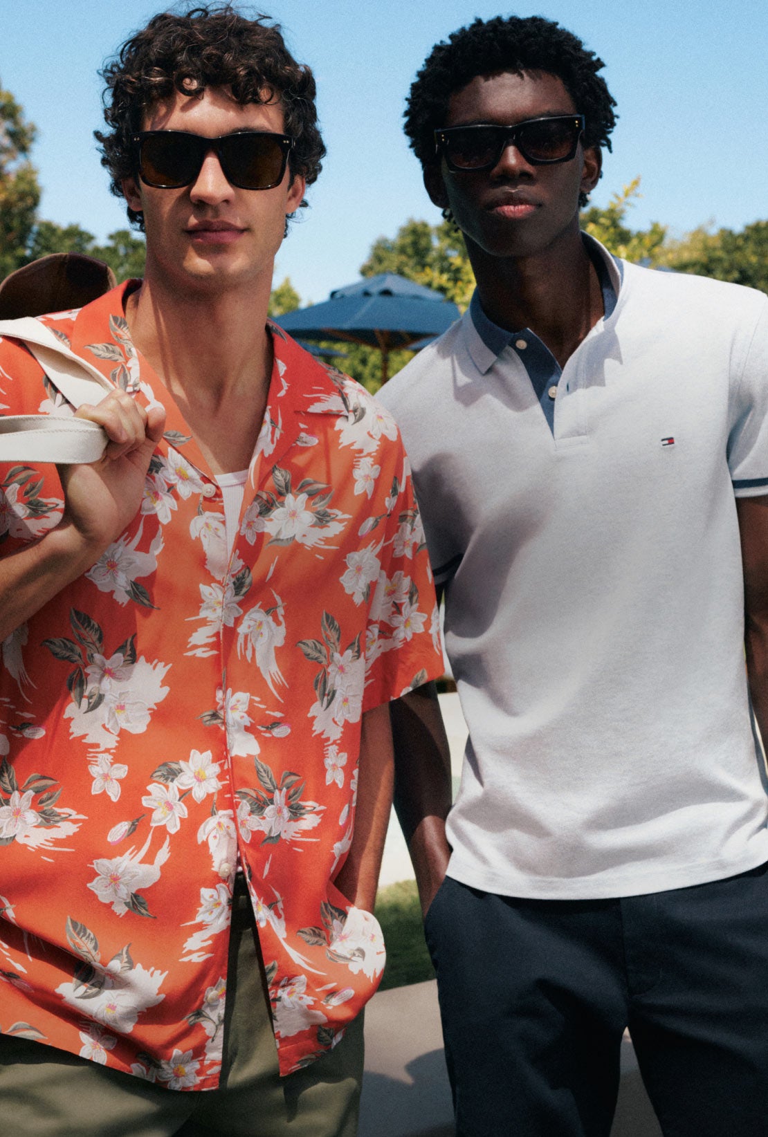 Two guys showing off their Tommy Hilfiger summer clothing essetials