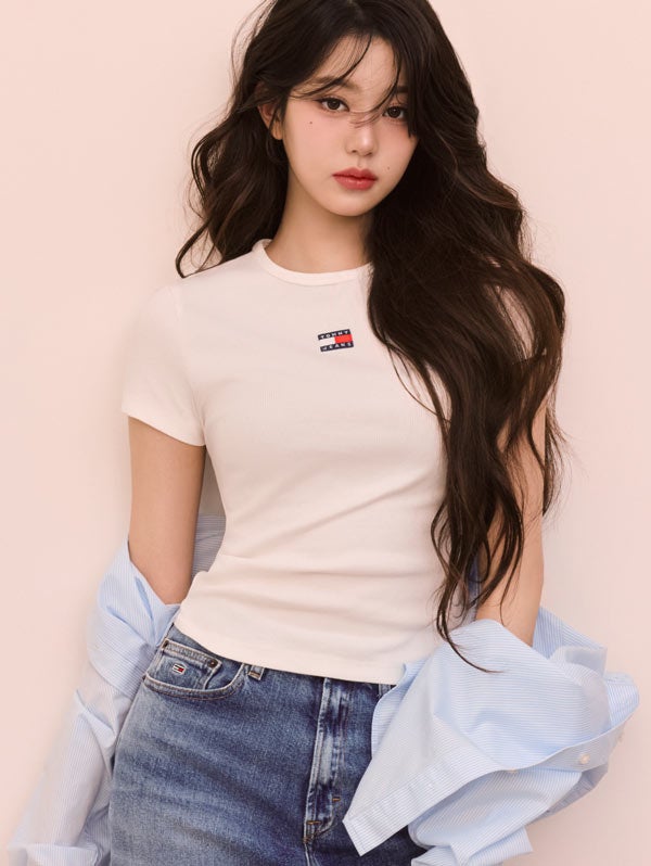 Won Young wearing Tommy Girl by Tommy Hilfiger t-shirt and jeans with button down draped on her arms