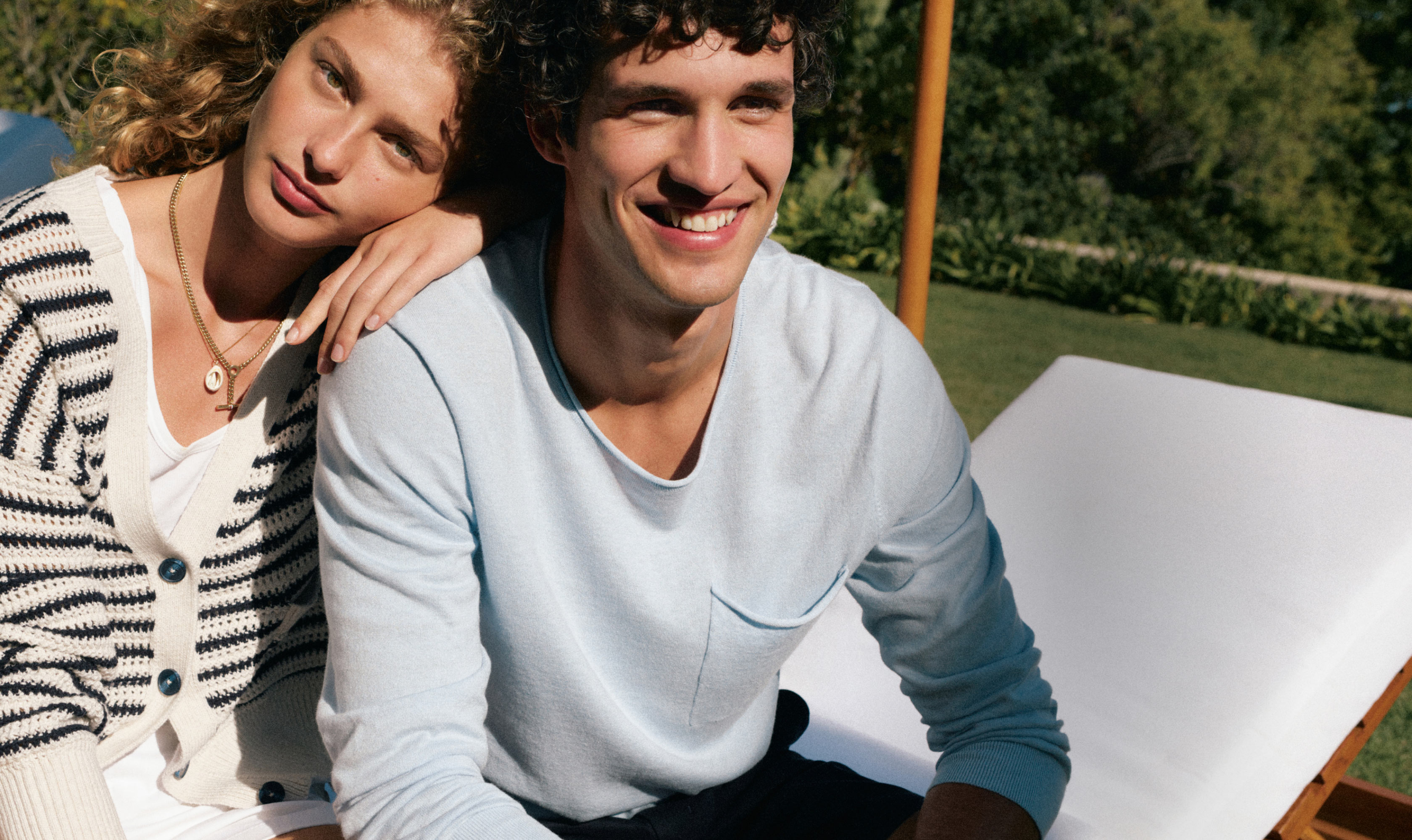 Woman leans on mans shoulder both dressed in Tommy Hilfiger