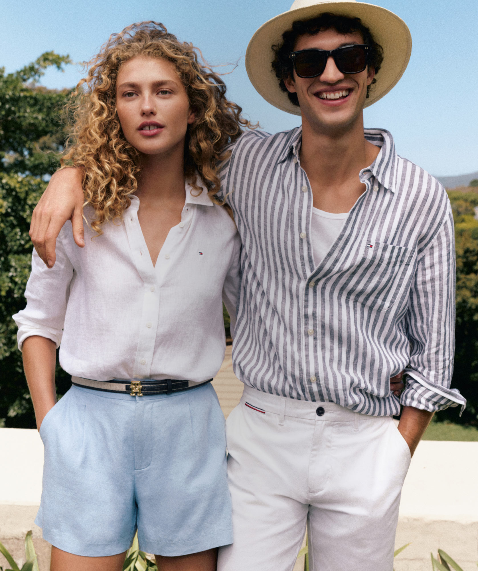 Man with arm around woman dressed in Tommy Hilfiger linen essentials