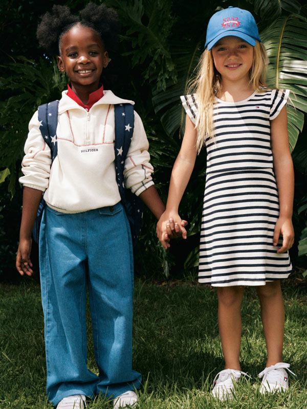 Kids looking into camera wearing Tommy Hilfiger polo and dress