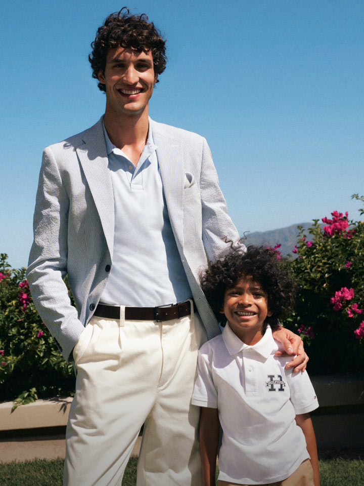 Man with arm over boys shoulder both wearing Tommy Hilfiger