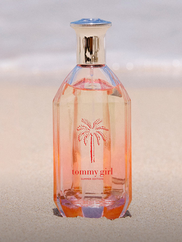 Tommy Hilfiger fragrance bottle laying down on the beach