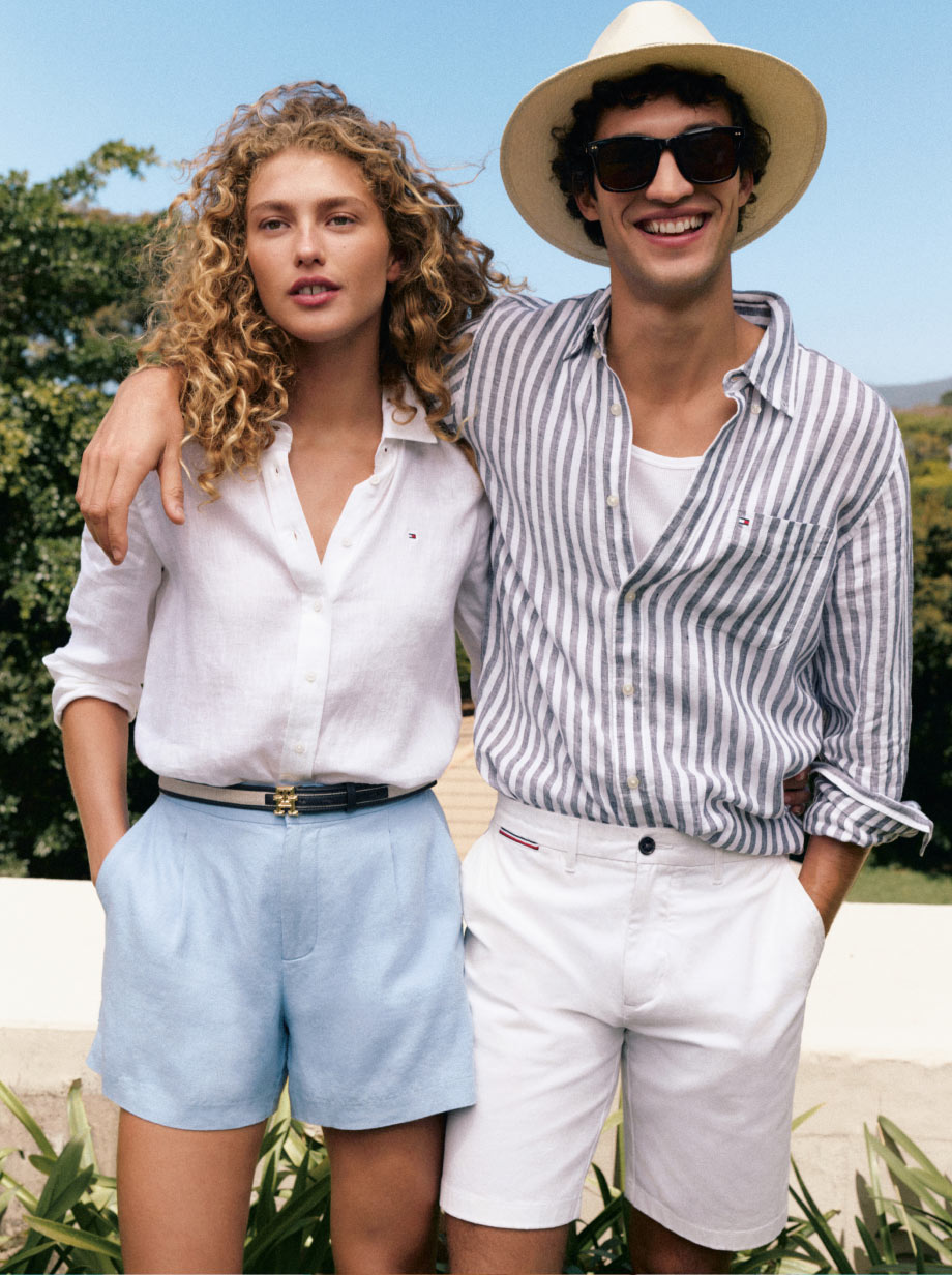Man and woman with arms around each other dressed in Tommy Hilfiger linen essentials 