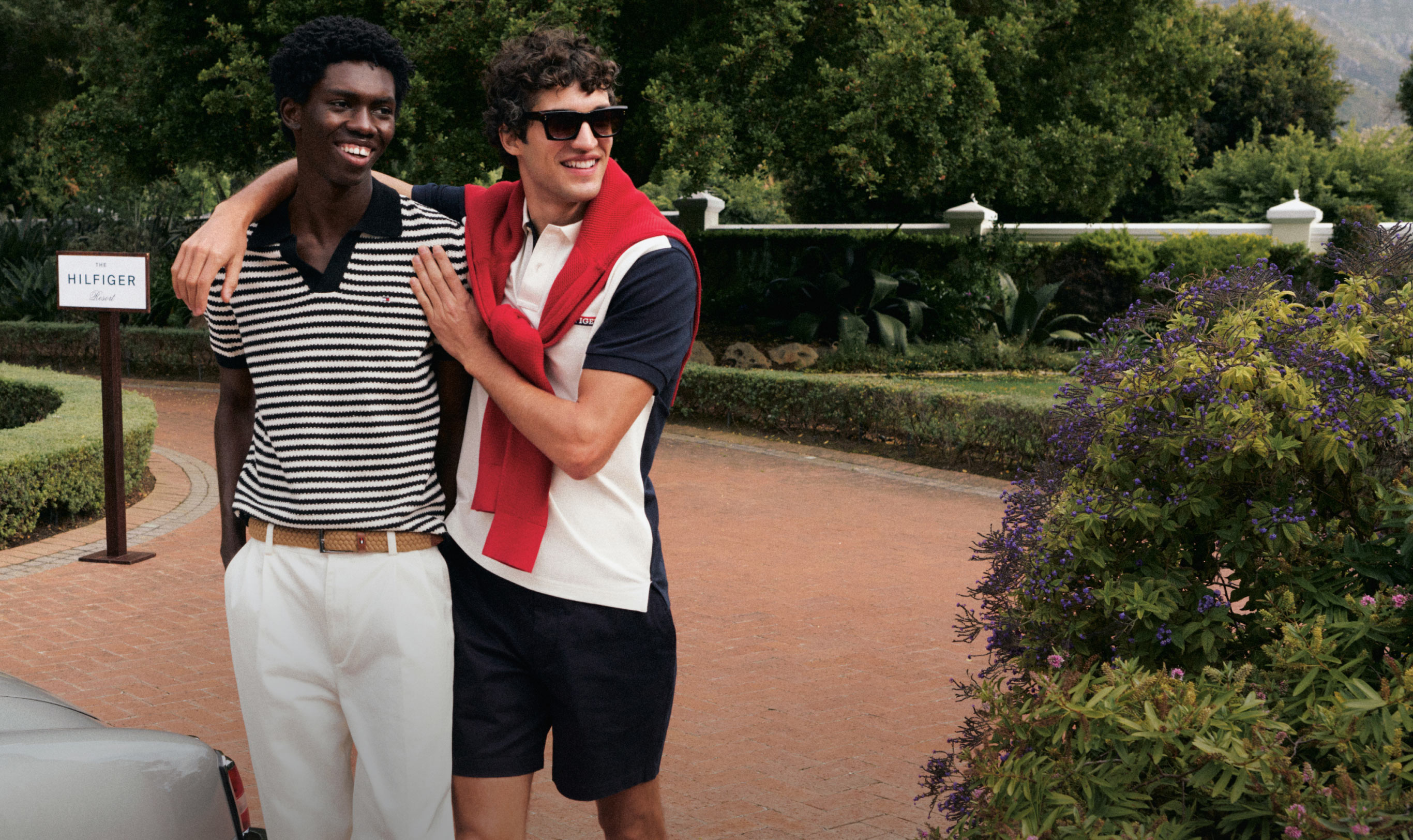 Woman leans on mans shoulder both dressed in Tommy Hilfiger