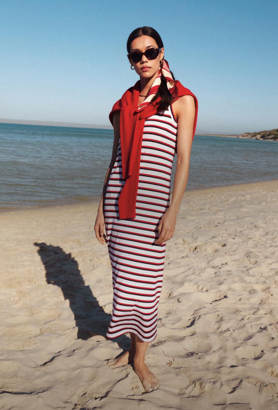 Woman dressed in Tommy Hilfiger stripped midi dress on the beach
