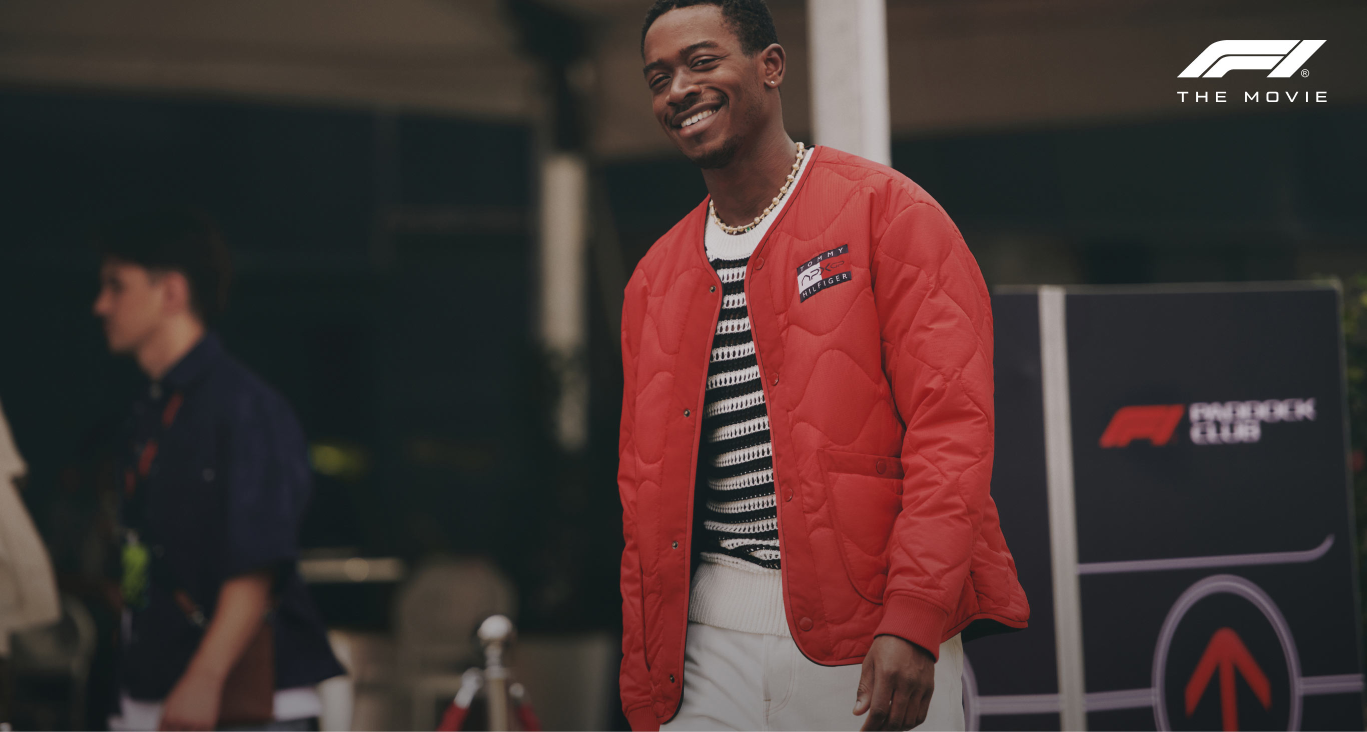 Damson Idris wearing Tommy Hilfiger X F1 APXGP red jacket