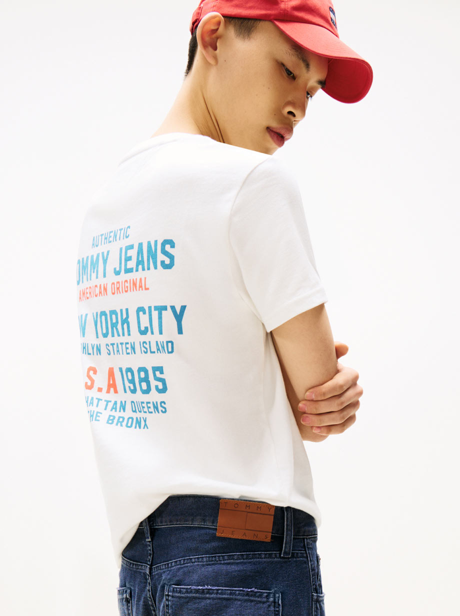 Man looking over his shoulder wearing a printed Tommy Hilfiger t-shirt
