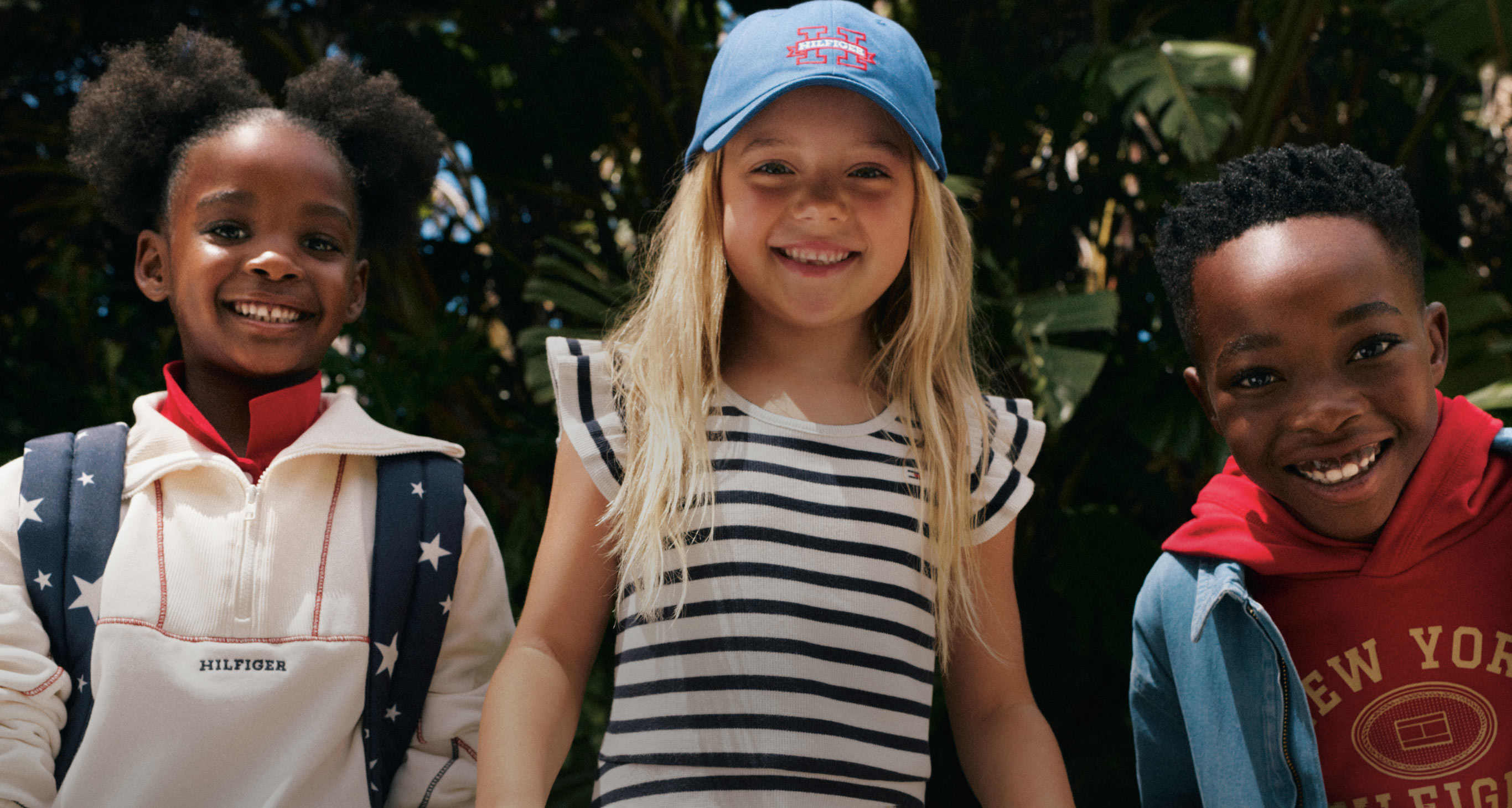 Kids smiling wearing Tommy Hilfiger for their first day of school