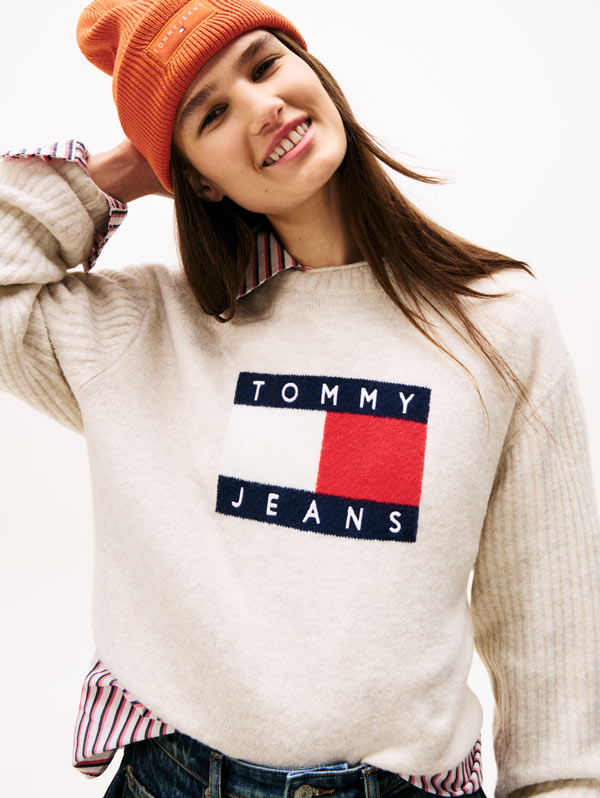 A women standing wearing a Tommy Jeans sweater