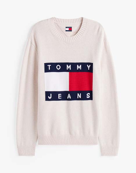 Cream Tommy Hilfiger crewneck sweater featuring the classic red, white, and navy flag logo across the chest.