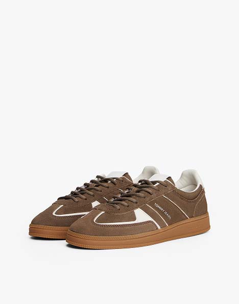 Brown suede Tommy Jeans sneaker with white laces, a gum sole, and side logo detailing.