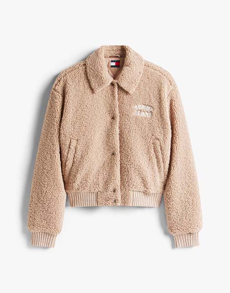 Beige faux shearling Tommy Jeans bomber jacket with zip front and ribbed cuffs.