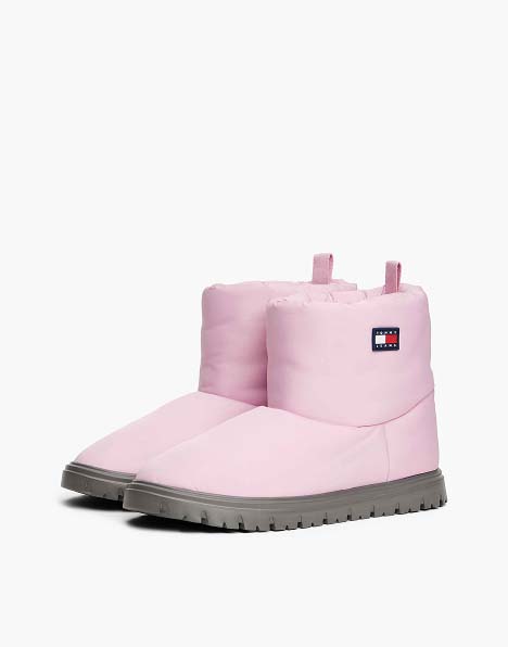 Light pink Tommy Jeans ankle boots with pull tabs and rugged rubber soles.