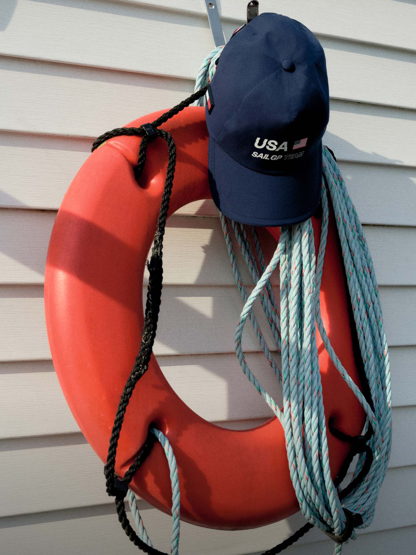 Ring buoy with a Tommy Hilfiger hat on it.