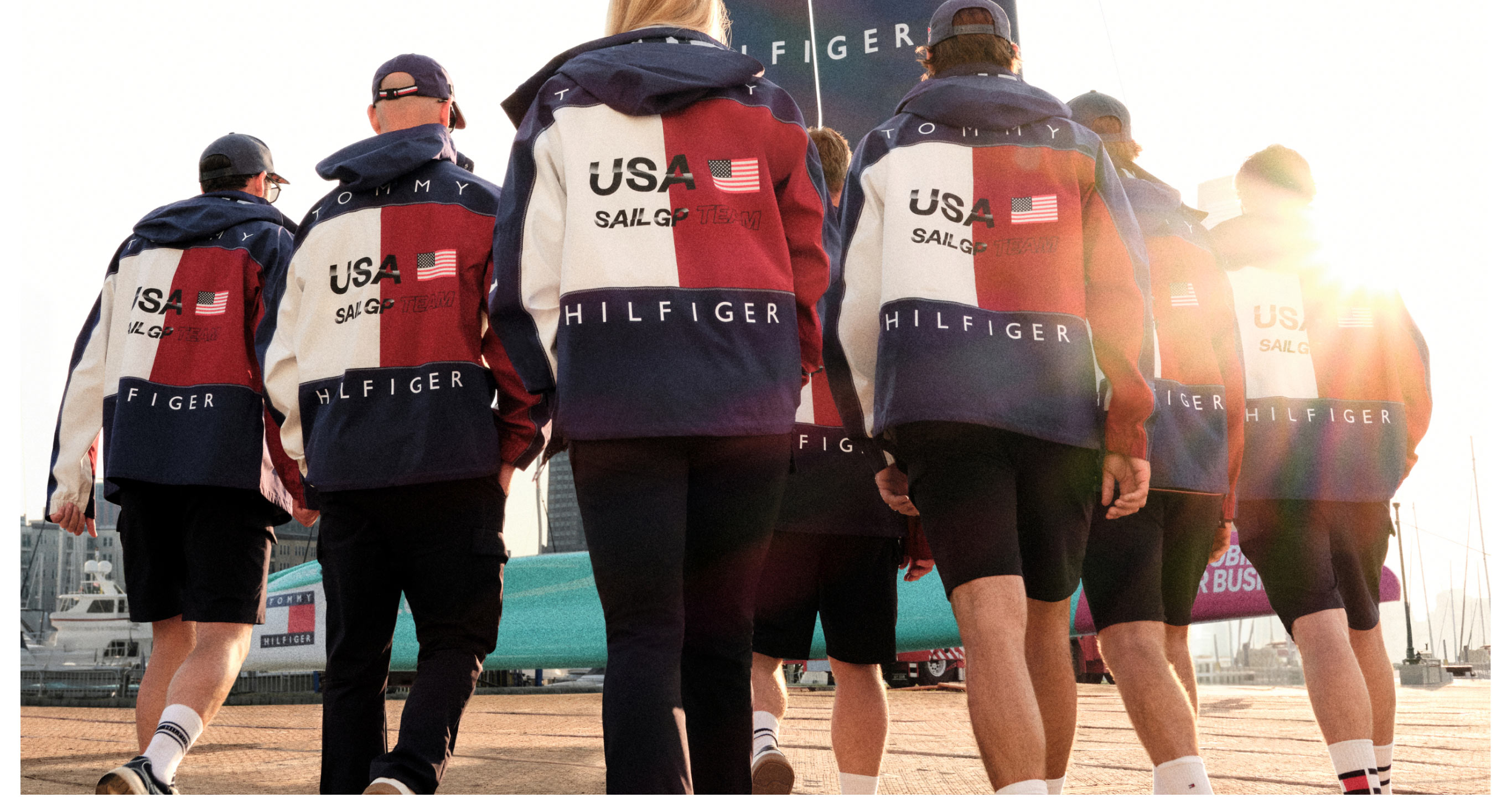 A group of men and women wearing the new Sail GP capsule from Tommy Hilfiger