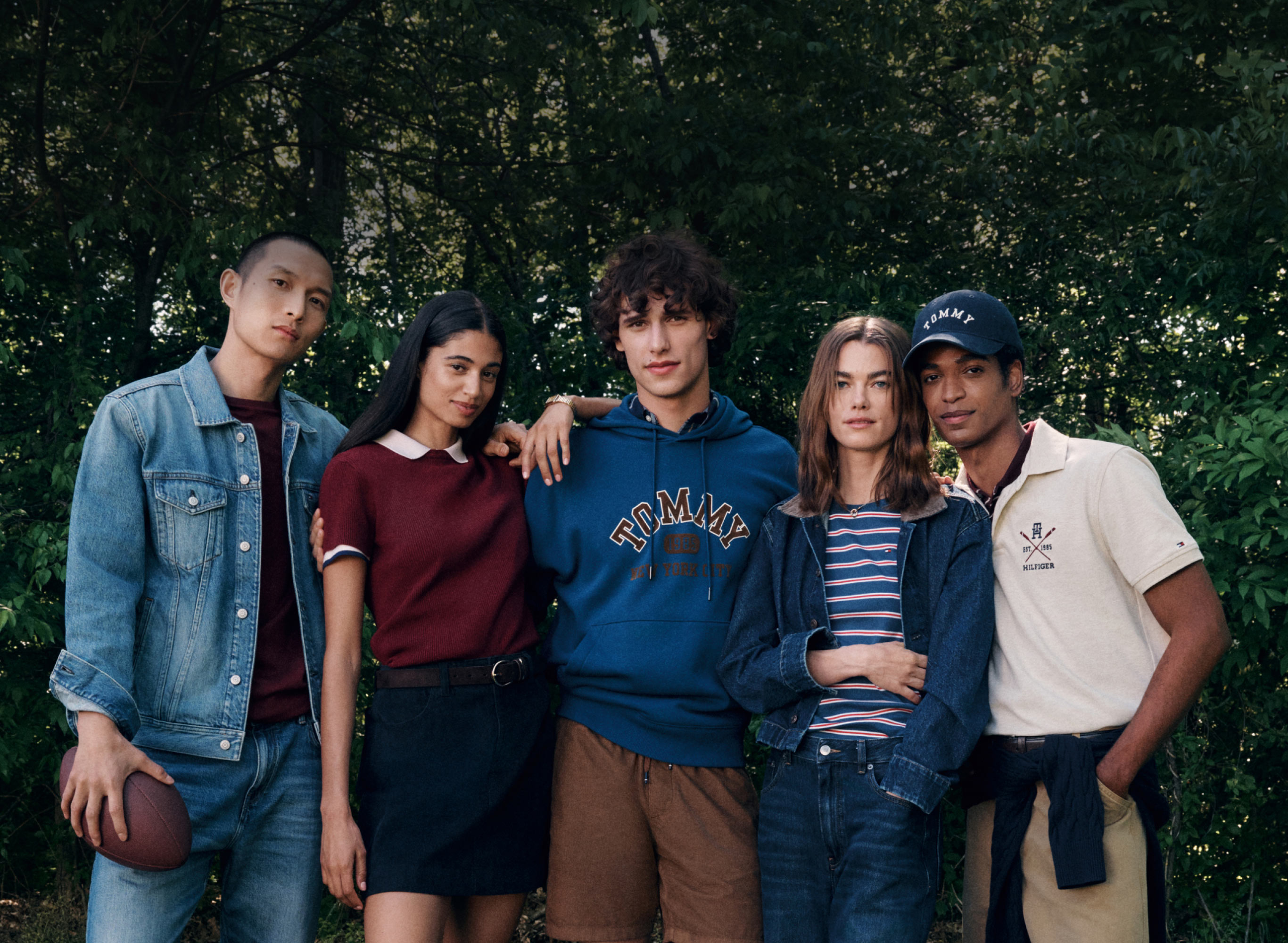 Group on a beach near the water dressed in classic Tommy Hilfiger red white and blue