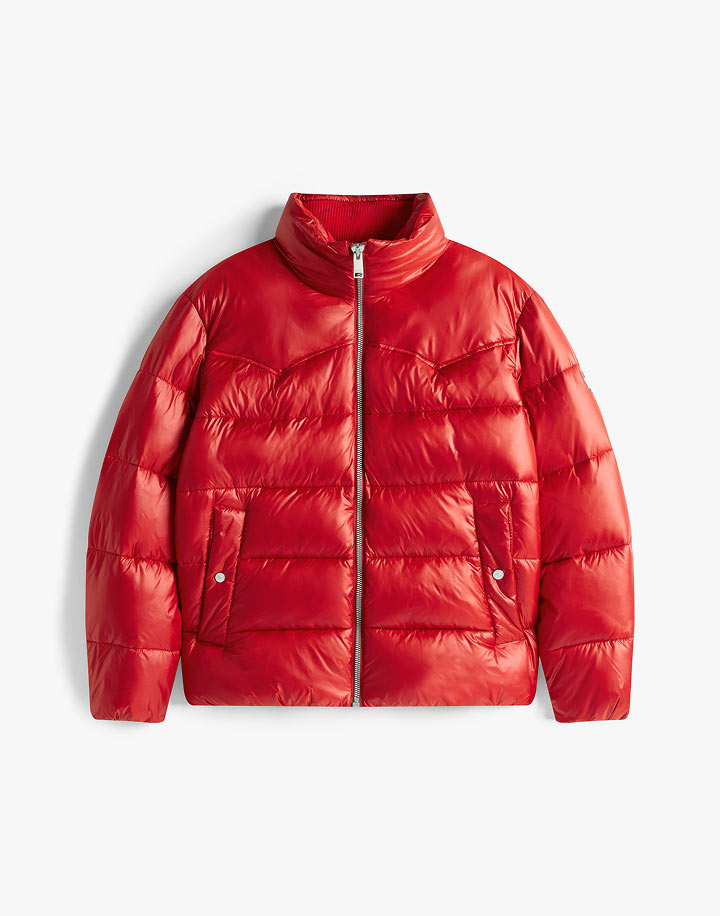 Red Tommy Jeans puffer jacket with a hood and small flag logo, photographed on a white background.