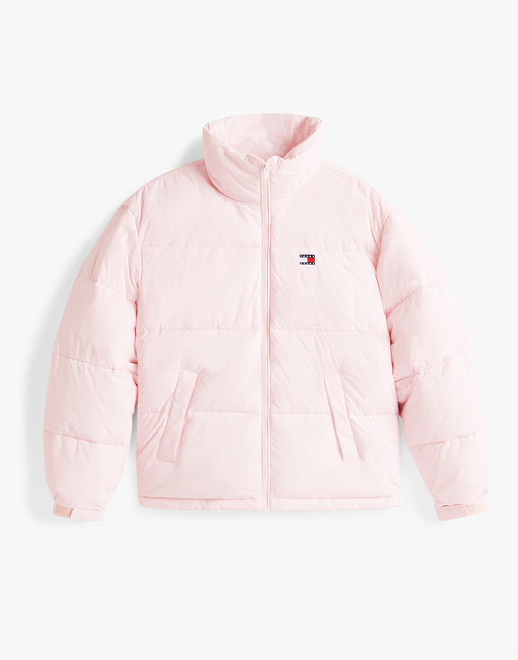Light pink Tommy Jeans puffer jacket with hood and small flag logo, photographed on a white background.