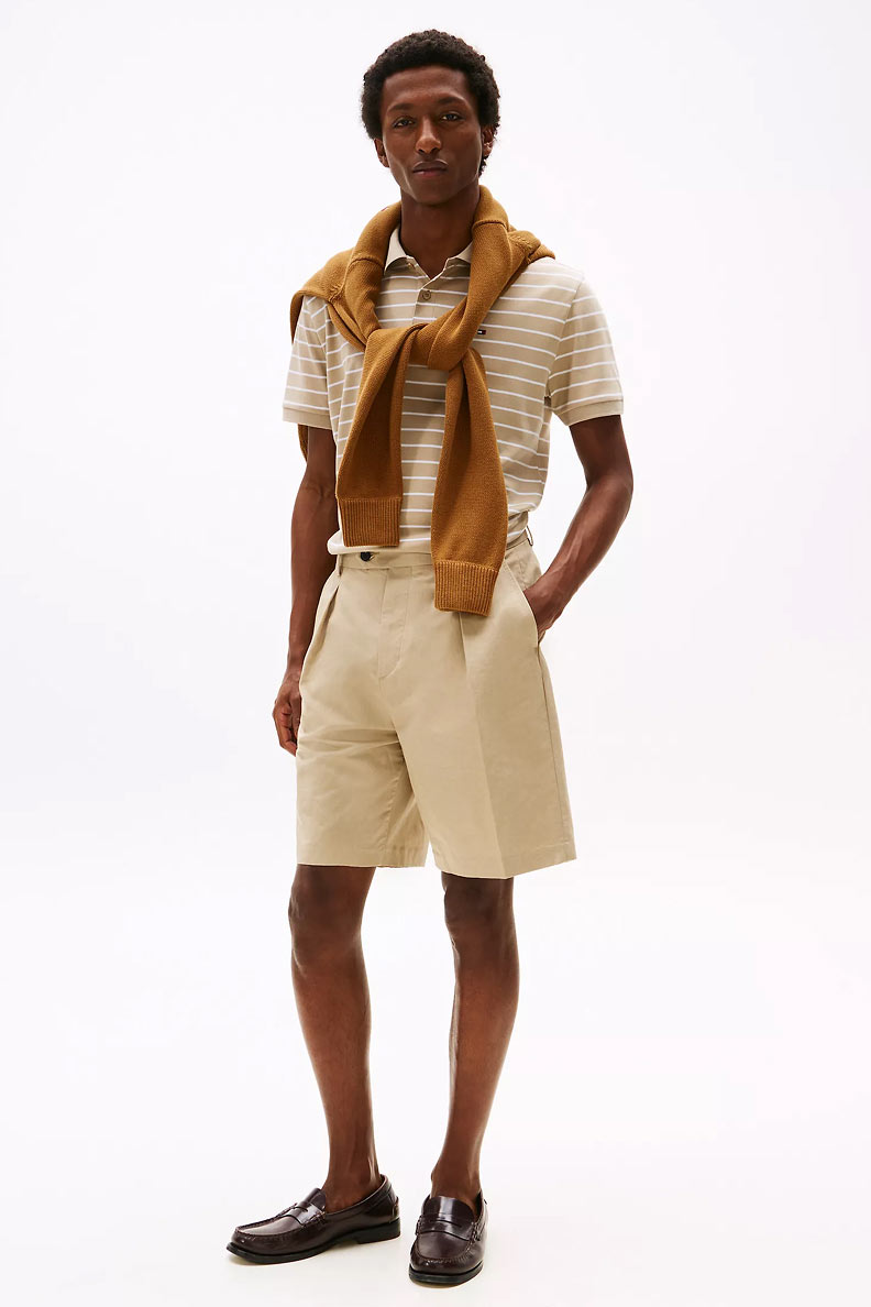 Man in a polo and shorts from Tommy Hilfiger.