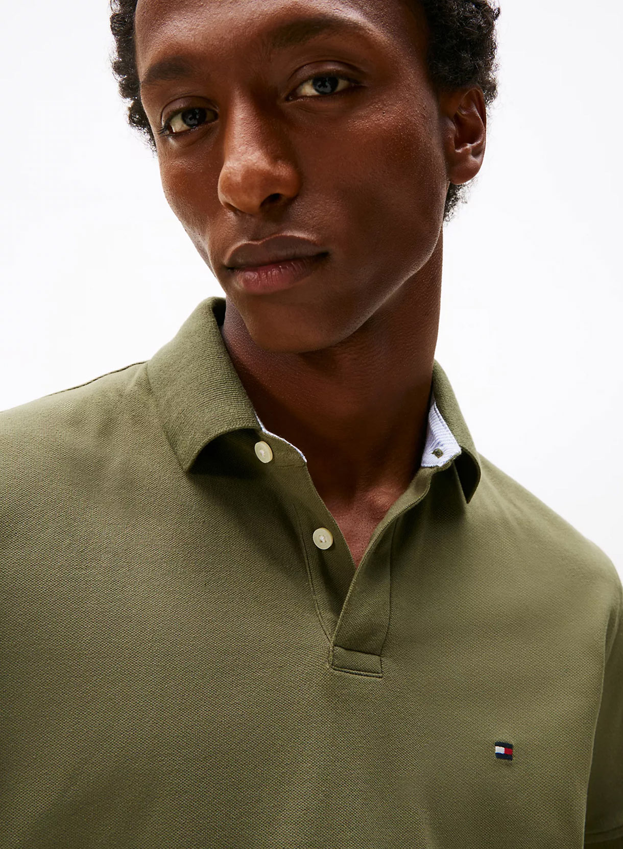 Man in a green Polo from Tommy Hilfiger.
