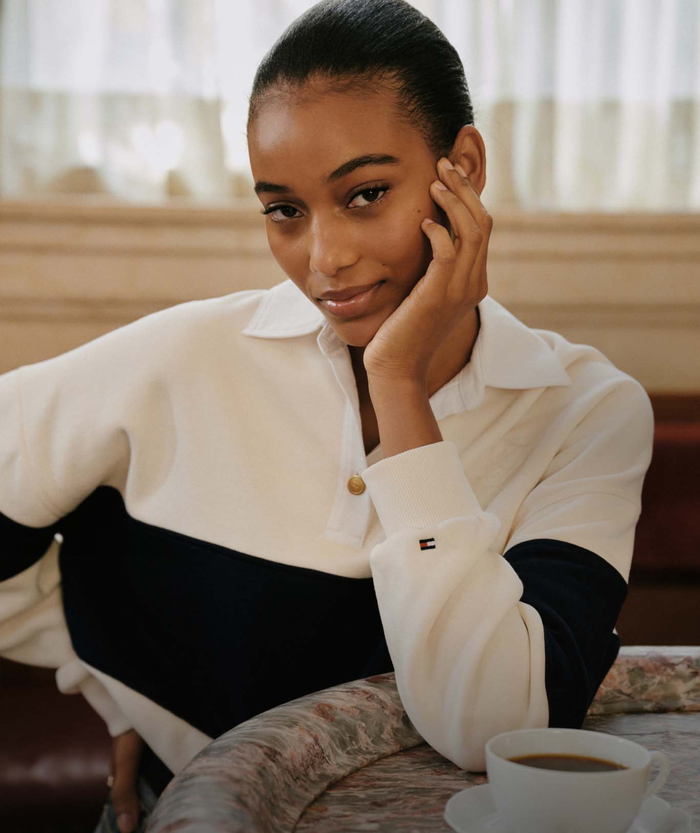 A female model in a colorblock zip-neck top.