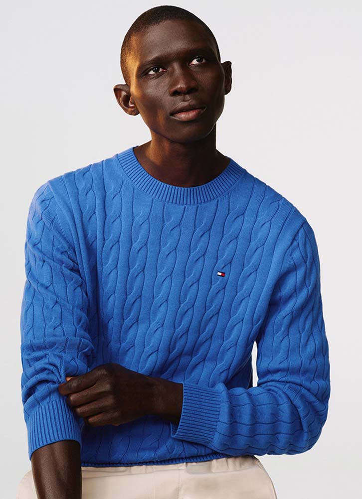 Model wearing a blue Tommy Hilfiger sweater