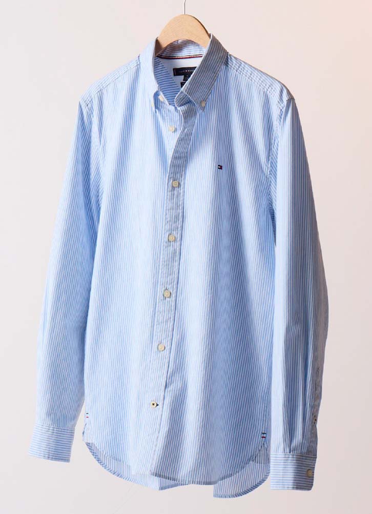 Light blue Tommy Hilfiger button-down shirt displayed on a hanger